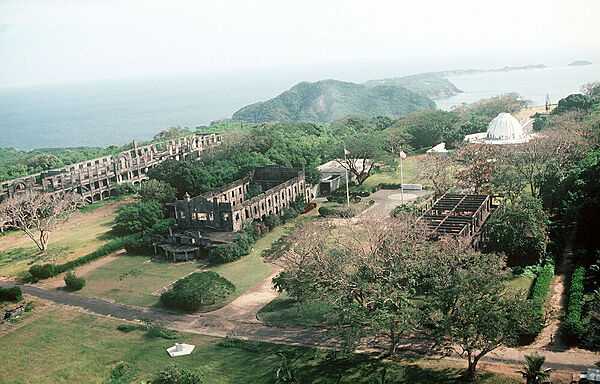 Aerial view of the monuments to American defenders of Corregidor Island during World War II. On the left are part of the ruins of the "Mile-Long Barracks" (prior to World War II reputed to be the longest barracks in the world) that housed the troops that defended the island; in the upper right is the Pacific War Memorial building. Photo courtesy of the US Navy / PH1 David C. Maclean.