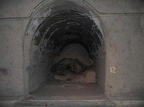 This lateral tunnel of the Malinta Tunnel complex was part of an underground fuel storage area. The collapsed fuel tank sits on a concrete cradle. Some of the lateral tunnels were collapsed when Japanese defenders blew themselves up during the recapture of the island by US and Filipino forces (23 February 1945). These collapsed laterals have never been excavated.