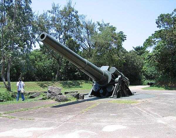 A 12-inch seacoast gun emplaced at Battery Hearn on Fort Mills (Corregidor). Battery Hearn was one of the last fortifications built on Fort Mills prior to limitations of the Washington Naval Treaty taking effect in the 1920s. The 12-inch guns were the longest range weapons (27 km (16 mi)) on Corregidor and fired on Japanese forces on Bataan Peninsula. Following the surrender of Corregidor on 6 May 1942, Battery Hearn was the scene of a famous photograph of Japanese soldiers celebrating their victory on top of the guns.