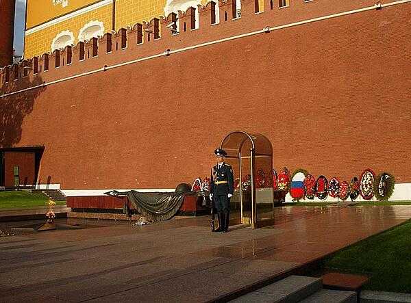 The Tomb of the Unknown Soldier in Moscow is a war memorial dedicated to Soviet soldiers killed during World War II. It is located in the Alexander Garden at the Kremlin Wall. First unveiled in 1967, a tombstone was added in 1975. The eternal flame emanates from the center of a five-pointed star located in front of the tombstone.