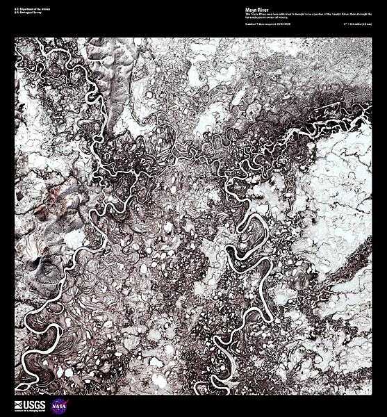 The Mayn River (on the left), seen here in a false color satellite image with a portion of the Anadyr River (on the right), flows through the far northeastern corner of Siberia. Both rivers carry a great deal of sediment and over time have created an amazing number of oxbow lakes. In this forest-tundra zone, both rivers remain frozen for 8 to 9 months out of the year. Image courtesy of USGS.