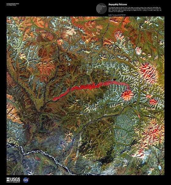 The prominent crimson streak in the center of this false-color satellite image represents the remains of a 50 km (31 mi) lahar (volcanic mudflow) that cut a strip of barren rock through rich vegetation surrounding the Anyuyskiy Volcano. The currently dormant volcano is the orange circular shape at the right end of the streak. Remote and largely inaccessible, the Kamchatka Peninsula is a rugged collection of towering volcanic peaks, steep valleys, active geysers, and wild, snow-fed rivers and streams.  This volcano is part of the UNESCO World Heritage Site &quot;Volcanoes of Kamchatka.&quot; For other active volcanoes in Russia, see the Natural hazards-volcanism subfield in the Geography section. Image courtesy of USGS.