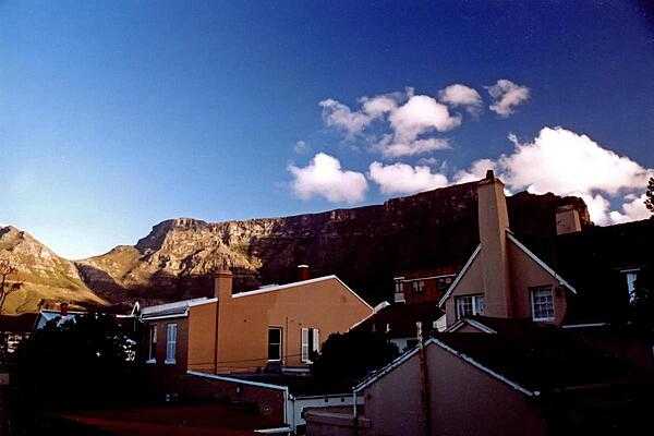 Table Mountain - a level plataeu about 3 km (2 mi) from side to side - overlooking some homes in Cape Town.