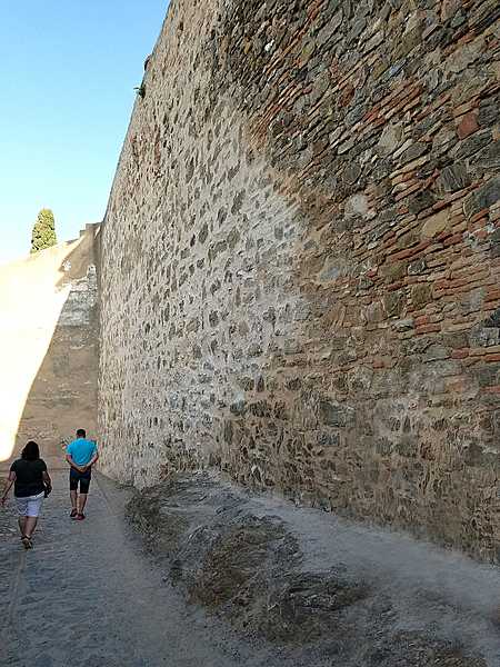 The stone walls in the Alcazaba in Malaga show different periods of construction. The Alcazaba is a complex of palaces that sits high atop a hillside. It was built by the Moors in the 11th century and formerly connected to the Gibralfaro fortification that overlooks the city and is situated higher still.