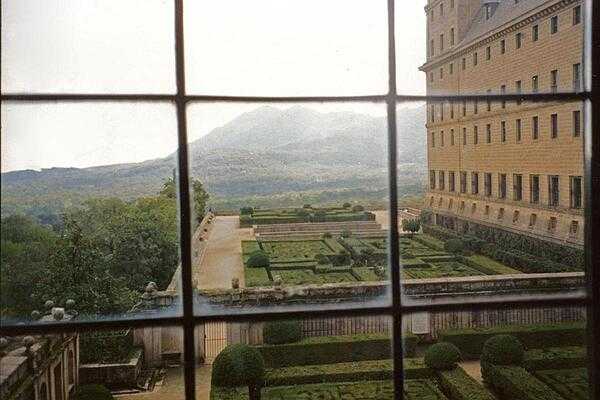 View of the gardens through a window at the El Escorial.