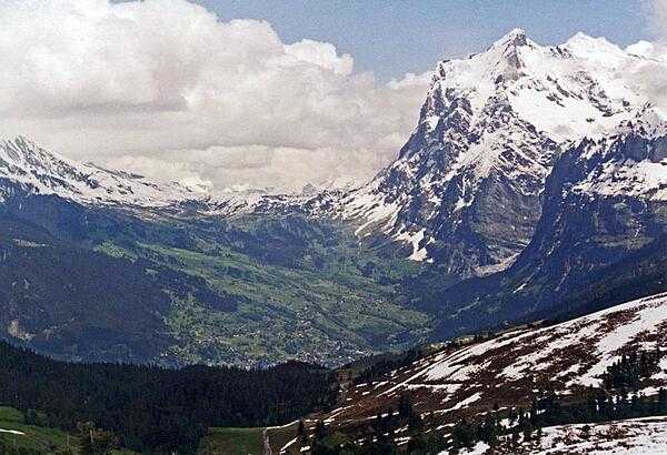 Mount Wetterhorn (3,692 m; 12,110 ft), near Grindelwald, overlooks the upper reaches of an Alpine valley - still snow covered in June.