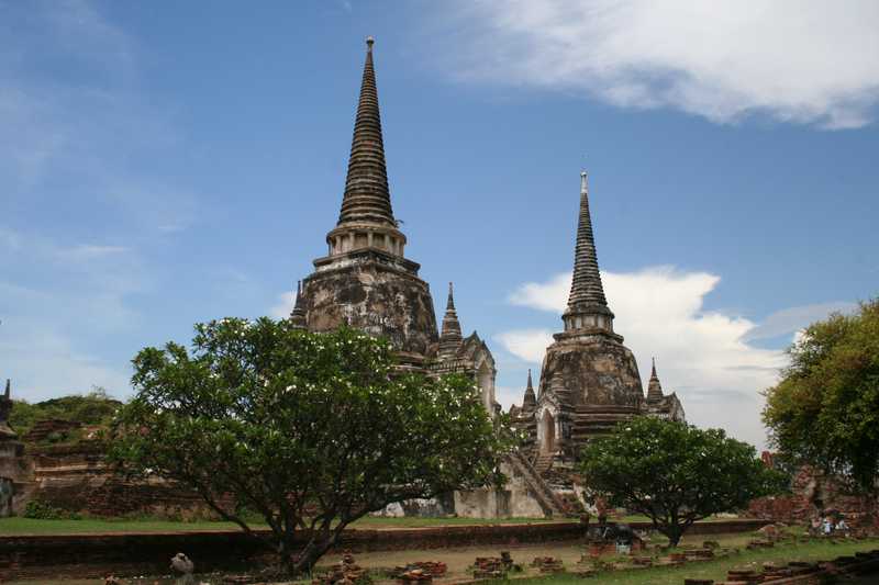 Two of the three restored chedi that are part of Wat Phra Si Sanphet, the Temple of the Buddha Si Sanphet.  The bell-shaped chedi or stupas were originally gilded.  The Burmese army razed the temple in 1767.