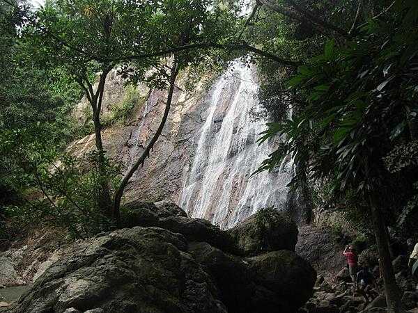 Na Muang Waterfall on Ko Samui. The water cascades some 30 meters (98 ft) down purple-hued rocks.