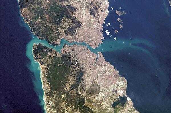 A view of Istanbul as taken from the International Space Station. The metropolis of 15 million occupies both sides of the entrance to the narrow, 32 km- (20 mi-) long Bosporus Strait connecting the Mediterranean and Sea of Marmara (south, on the right) to the Black Sea (north, on the left). When this image was taken, strong currents carried turbid coastal waters from the Black Sea through the Strait and into the Sea of Marmara. The sinuous waterway and harbor on the western shore are known as the Golden Horn. Image courtesy of NASA.