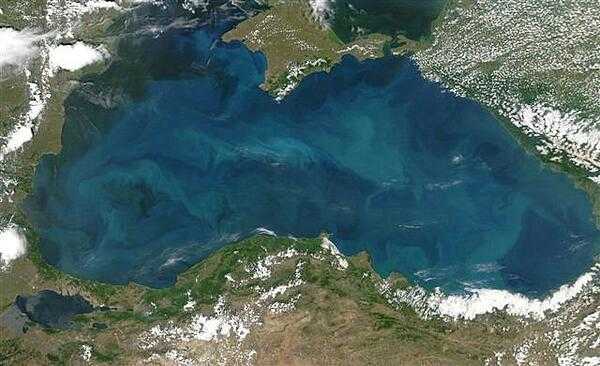 Swirls of color ranging from deep olive green to bright turquoise were created by a massive phytoplankton bloom that covered the entire surface of the Black Sea on this image taken 20 June 2006. Many of Europe&apos;s largest rivers, including the Danube, the Dnister, and the Dnipro (Dnieper) dump fresh water into the sea. The sea&apos;s only source of salty water is the narrow Bosporus Strait (in the southwest), which connects it to the Mediterranean Sea through the Sea of Marmara. Northern Turkey makes up the southern shore of the sea. The diamond-shaped landmass that projects into the sea from the north is Ukraine&apos;s Crimean peninsula. Photo courtesy of NASA.