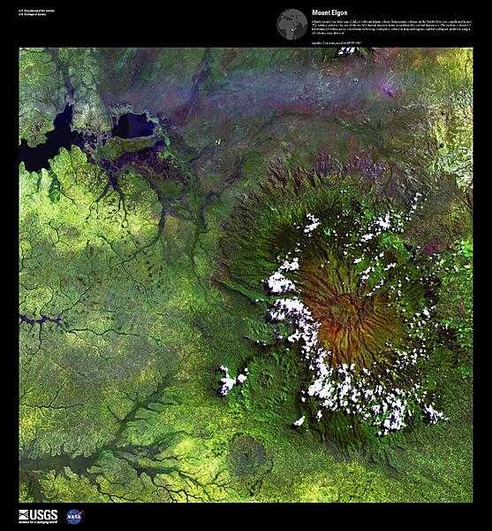 Clouds encircle the lofty rim of Mount Elgon, a huge, long-extinct volcano on the border between Uganda and Kenya, viewed in this enhanced satellite image. The solitary volcano has one of the world&apos;s largest intact calderas, a cauldron-like central depression. The caldera is about 6.5 km (4 mi) across and formed following an eruption, when the emptied magma chamber collapsed under the weight of volcanic rock above it. For active volcanoes in Uganda, see the Natural hazards-volcanism subfield in the Geography section. Image courtesy of USGS.