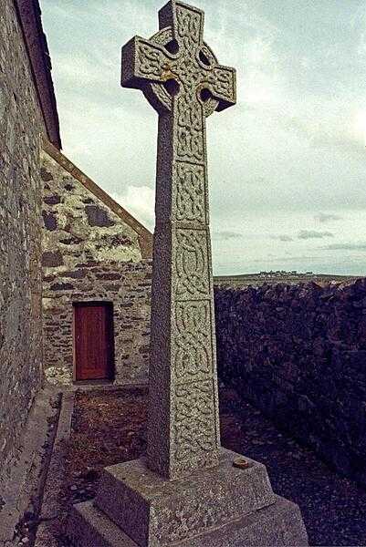 Celtic cross outside of St. Moluag&apos;s Church - Teampull Mholuaidh in Scots Gaelic - in the town of Eoropie on the Isle of Lewis in the Outer Hebrides of northern Scotland.