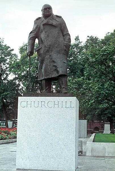The statue of Winston Churchill on the grounds of the Houses of Parliament building (Westminster Palace) in London.