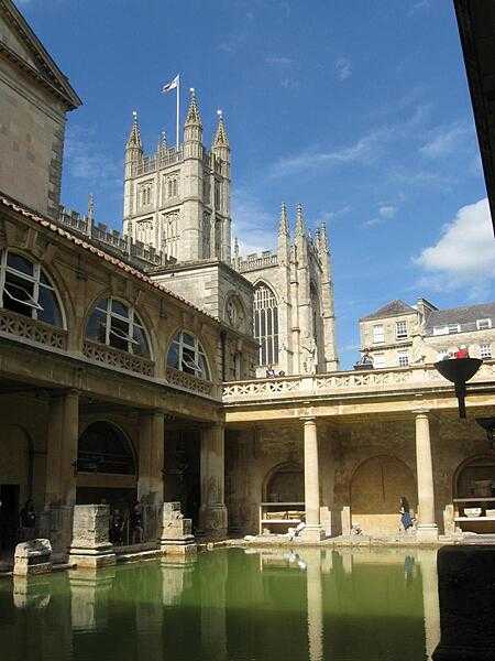A view of the reconstructed Great Bath of Aquae Sulis in Bath, with Bath Abbey in the background.