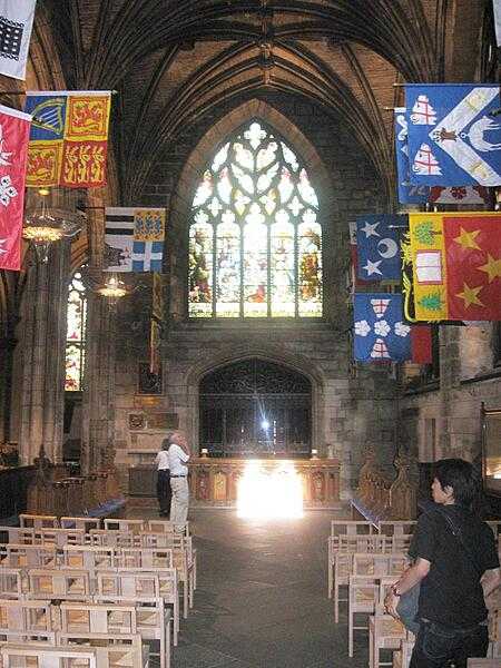Heraldic flags flank the Preston Aisle inside Saint Giles Cathedral, Edinburgh.