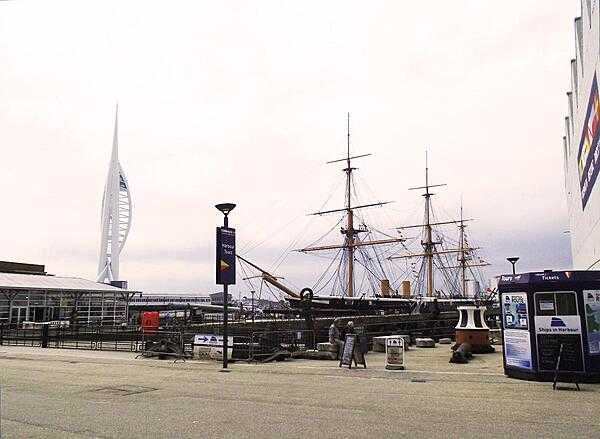 HMS Warrior docked in Portsmouth Harbor, England. The city&apos;s iconic Spinnaker Tower, opened in 2005, appears at the left. The tower&apos;s height is 170 m (560 ft); it has three viewing decks at 100-, 105-, and 110-meter levels.