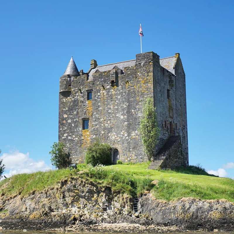 A closer view of Castle Stalker, the four-story tower house or keep set on a tidal islet on Loch Laich in Scotland. The island castle is one of the best-preserved medieval tower houses to survive in western Scotland.