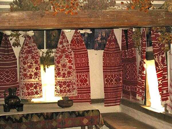 Embroidered towels, icons, and drying herbs and flowers decorate the interior of a peasant home at the Museum of Folk Architecture and Life in Pyrohiv, south of Kyiv.