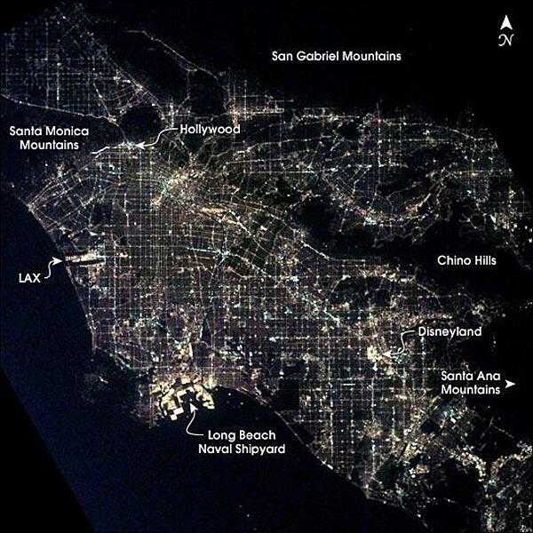 Los Angeles at night as seen from the International Space Station. After sunset, the borders of &quot;The City of Angels&quot; are defined as much by its dark terrain features as by its well-lit grid of streets and freeways. Over 13 million people inhabit the coastal basin bounded roughly by the Santa Monica and San Gabriel Mountains to the north and the Chino Hills and Santa Ana Mountains to the east and southeast. Image courtesy of NASA.