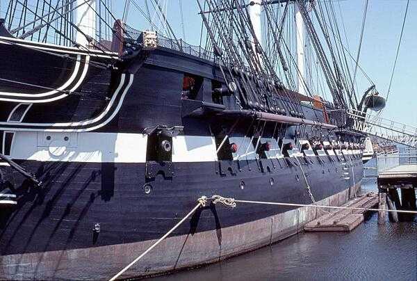 Gun ports of the USS Constitution. Although rated as a 44-gun frigate, the ship would often carry over 50 guns at a time. Constitution is 62 m (204 ft) long and 13.3 m (43.5 ft) at the beam. The height of the central mainmast is 67 m (220 ft).