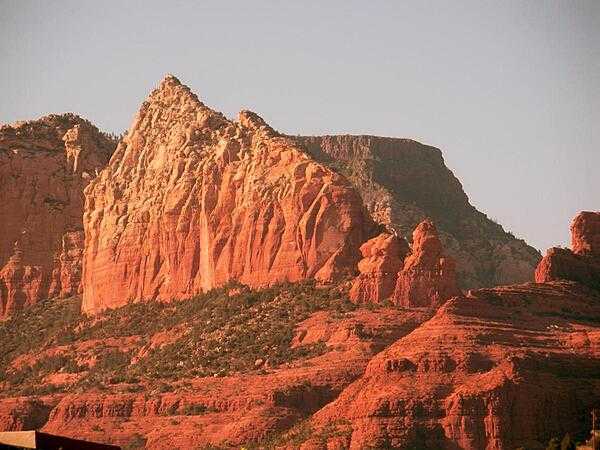 Part of the Red Rocks sandstone formation in the Sedona area of Arizona. The rocks appear to glow reddish orange in the early morning or evening sunlight.