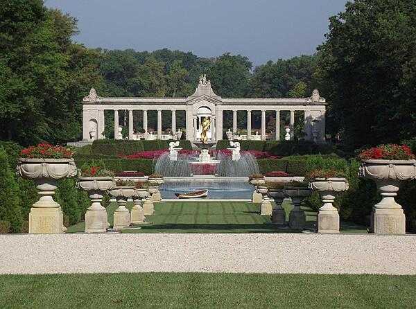 Fountain and pool at the end of the Long Walk at the Nemours Gardens, Wilmington, Delaware. The Gardens are the largest French formal gardens in North America and are patterned after the gardens of Versailles. The gilded statue represents Achievement.