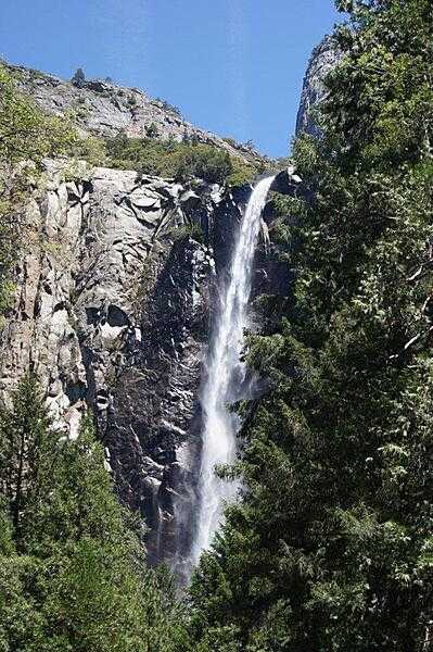 Bridalveil Falls is often the first waterfall seen by tourists coming into Yosemite Valley in California, it drops 189 m (620 ft) into the valley. The falls run all year, roaring during the spring runoff and appearing as a windblown &quot;bridal veil&quot; during the rest of the year.