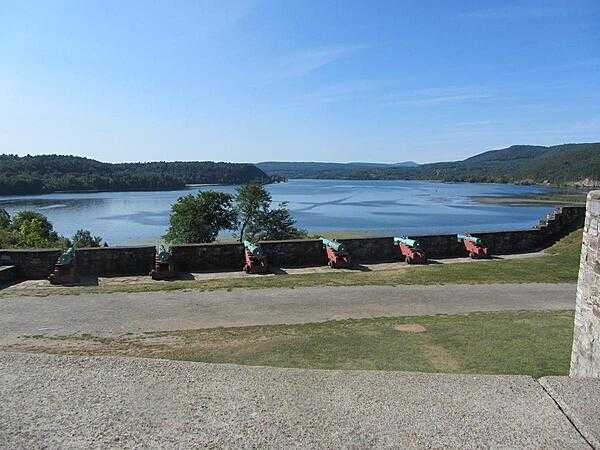 View from the battlements of Fort Ticonderoga in New York on Lake Champlain showing cannon, the lake, and part of Mount Defiance. After the fort was captured by an American force led by Ethan Allen and Benedict Arnold in May 1775, its cannon were transported to Boston where their deployment on Dorchester Heights forced the British to evacuate the city in March 1776.