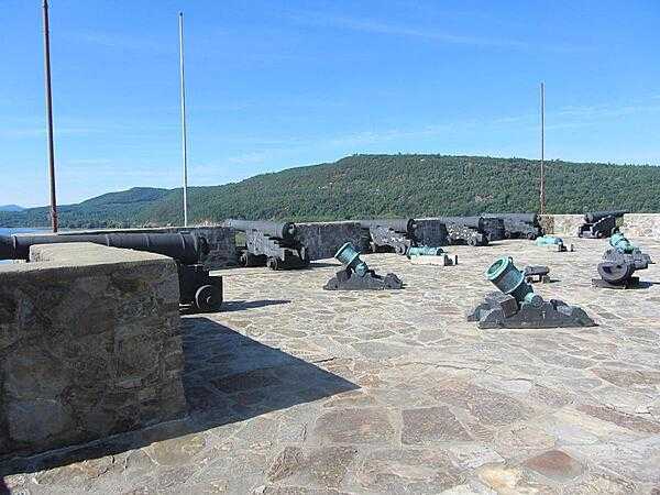 View from the battlements of Fort Ticonderoga on Lake Champlain in New York state showing cannon, mortars, the lake, and Mount Defiance. The fort controlled a river portage between Lake Champlain and Lake George and then to the Hudson River. This was the principal trade route between the Hudson River Valley and the French-controlled Saint Lawrence River Valley.