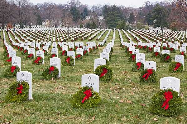 Remembrance wreaths on headstones at Arlington National Cemetery.