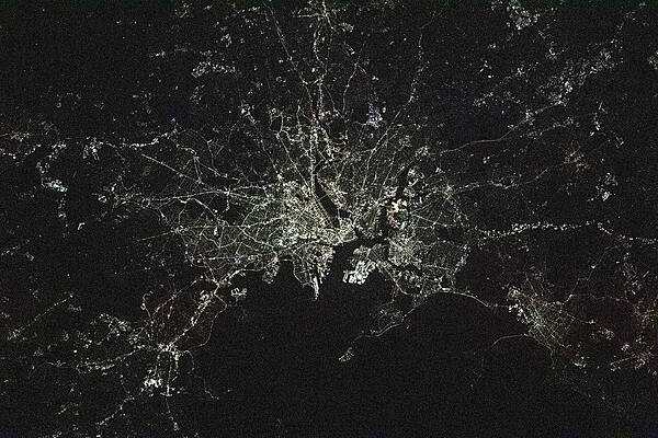 The lights of the city of Boston seemingly spread from a central point in this image taken by the crew of the International Space Station. Photo courtesy of NASA.