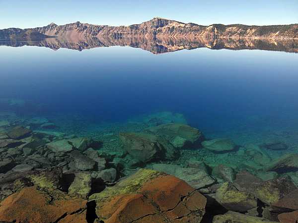 Crater Lake, Oregon in summer III. A view from the lake shore, with Llao Rock in the distance. Photo courtesy of the US National Park Service.