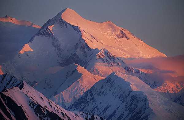 Alaska is home to North America’s highest peak, Denali, seen in the background in this picture.  Denali, at the heart of the six-million-acre Denali National Park and Preserve, stands 6,190 m (20,310 ft) above sea level and is the third-highest of the Seven Summits (the tallest peaks on all seven continents). Denali has five large glaciers flowing off its slopes. The mountain’s name comes from Koyukon, a Native Alaskan language, and means “the high one” or “the tall one.”