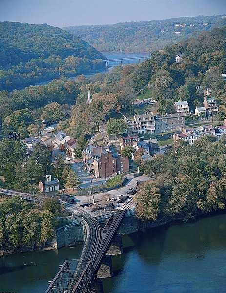 Harpers Ferry is a historic town in Jefferson County, West Virginia, in the lower Shenandoah Valley.  Happily situated at the confluence of the Potomac and Shenandoah Rivers, it marks the spot where the US states of Maryland, Virginia, and West Virginia meet. This view of Harpers Ferry is taken from Maryland Heights.  Photo courtesy of the National Park Service.