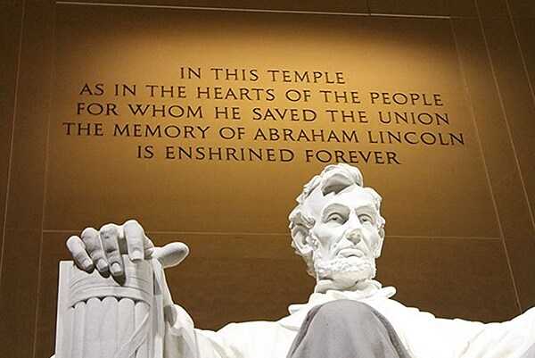 The inscription in the Lincoln Memorial glows behind the statue at night. Photo courtesy of the National Park Service.