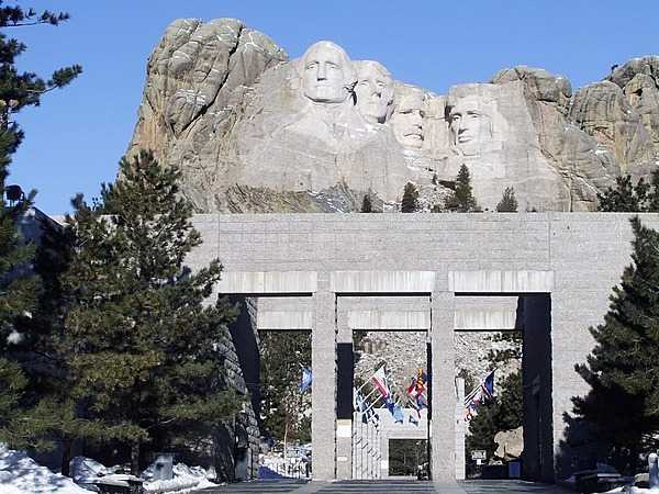 Mount Rushmore National Memorial in the Black Hills of South Dakota features the sculptures of four US presidents: Washington, Jefferson, Roosevelt, and Lincoln; it towers over the Avenue of Flags near the visitor center. Image courtesy of the US National Park Service.