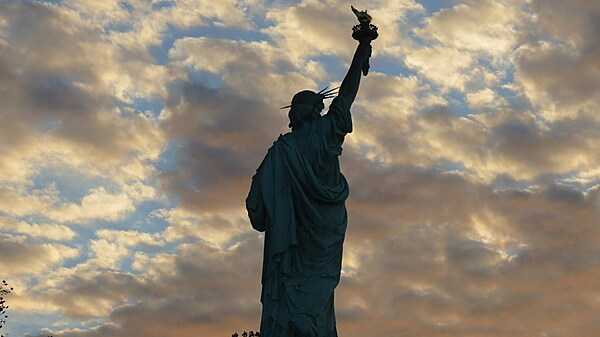 The Statue of Liberty faces a dramatic cloud display. Photo courtesy of the National Park Service.