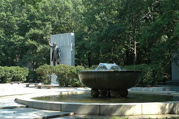 Memorial plaza, statue, and fountain among the trees of Theodore Roosevelt Island. Photo courtesy of the National Park Service.