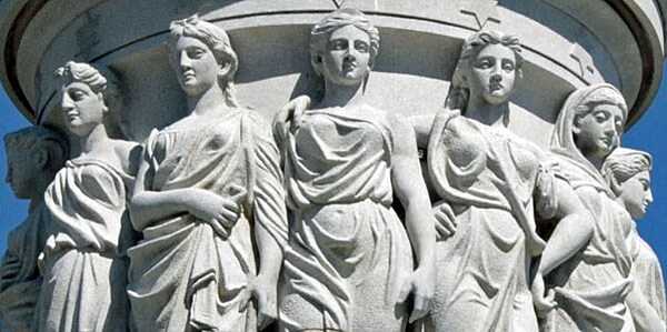 Close up of a group of figures representing the thirteen original American colonies as seen on the podium of the Yorktown Victory Monument in Yorktown, Virginia. Photo courtesy of the National Park Service.