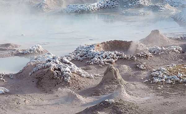 Fountain Paint Pot in the Lower Geyser Basin of Yellowstone National Park. Splatter cones are encrusted with newly fallen snow that will soon melt in the steam. Image courtesy of the US National Park Service/Diane Renkin.