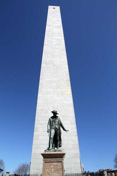 On 17 June 1775, the American Revolution’s first major battle occurred outside of Boston. Though named “The Battle of Bunker Hill,” the original objective of both sides was nearby Breed’s Hill. The American militia only withdrew from their entrenched positions after inflicting huge casualties on the British and after running out of ammunition. The Bunker Hill Monument, constructed between 1825 and 1843 on Breed’s Hill, is a 67-m (221-ft) high granite obelisk fronted by a statue of William Prescott, the leader of the American rebels. Prescott is noted for telling his troops, “Do not fire until you see the whites of their eyes."