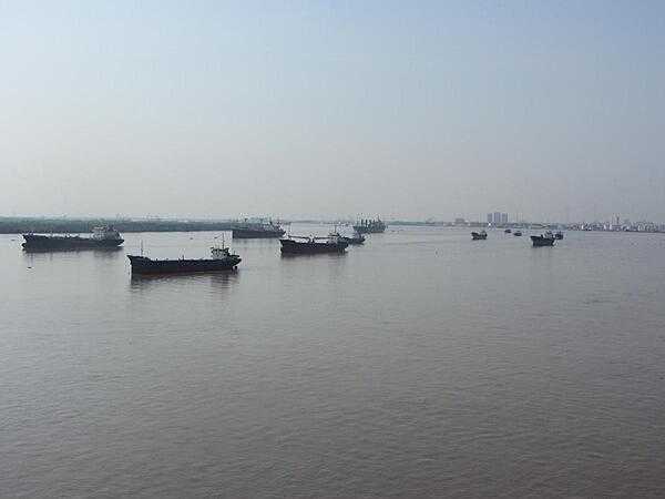 A small flotilla of boats on the  Saigon River, which serves as the main water source for the port of Saigon.