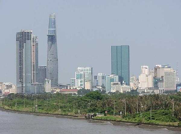 View of Ho Chi Minh City (aka Saigon) from the Saigon River. Saigon is Vietnam&apos;s major port and, with 8 million inhabitants, its largest city. It was called Saigon until 1975 when it was renamed Ho Chi Minh City following its capture by North Vietnamese communist forces. Although the city&apos;s commercial core is officially called Saigon, the entire city is widely referred to as Saigon even in the North. The city was architecturally influenced by the French during their colonial occupation of Vietnam. Numerous classical Western-style building in the city reflect this, so much so that Saigon was referred to as &quot;The Pearl of the Far East&quot; or &quot;Paris in the Orient.&quot; In more recent years, a building boom has transformed the skyline of the city.