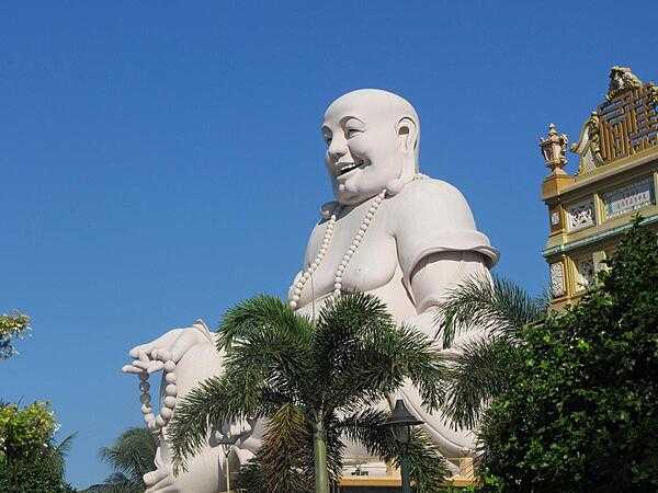 Laughing Buddha at the Vinh Trang Pagoda near the city of My Tho. First completed in 1851, the Vinh Trang temple has been reconstructed a number of times.