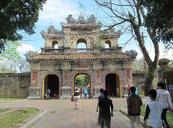 Gate leaving the grounds of the former Imperial City in Hue. Located on the Perfume River in central Vietnam, Hue was the capital of Vietnam from 1802 until 1945. A walled citadel, 2 km by 2 km, as well as a moat, surrounded the city. Inside the citadel was the Imperial City. Many of the buildings of the Imperial City were destroyed during the Vietnam War. Some reconstruction has begun.