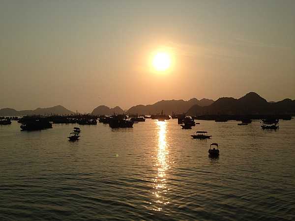 Sunset over Cat Ba, a large island that forms the southwestern boundary of Lan Ha Bay. Most of the island  is a national park.