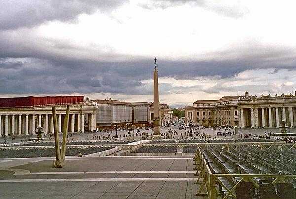 Looking past the obelisk that stands at the center of St. Peter&apos;s Square in the Vatican out to the city of Rome.