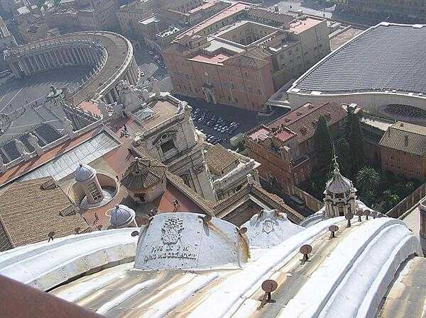 Looking down from the dome of St. Peter&apos;s Basilica. St. Peter&apos;s Square is in the upper left; the modern Audience Hall in the upper right.